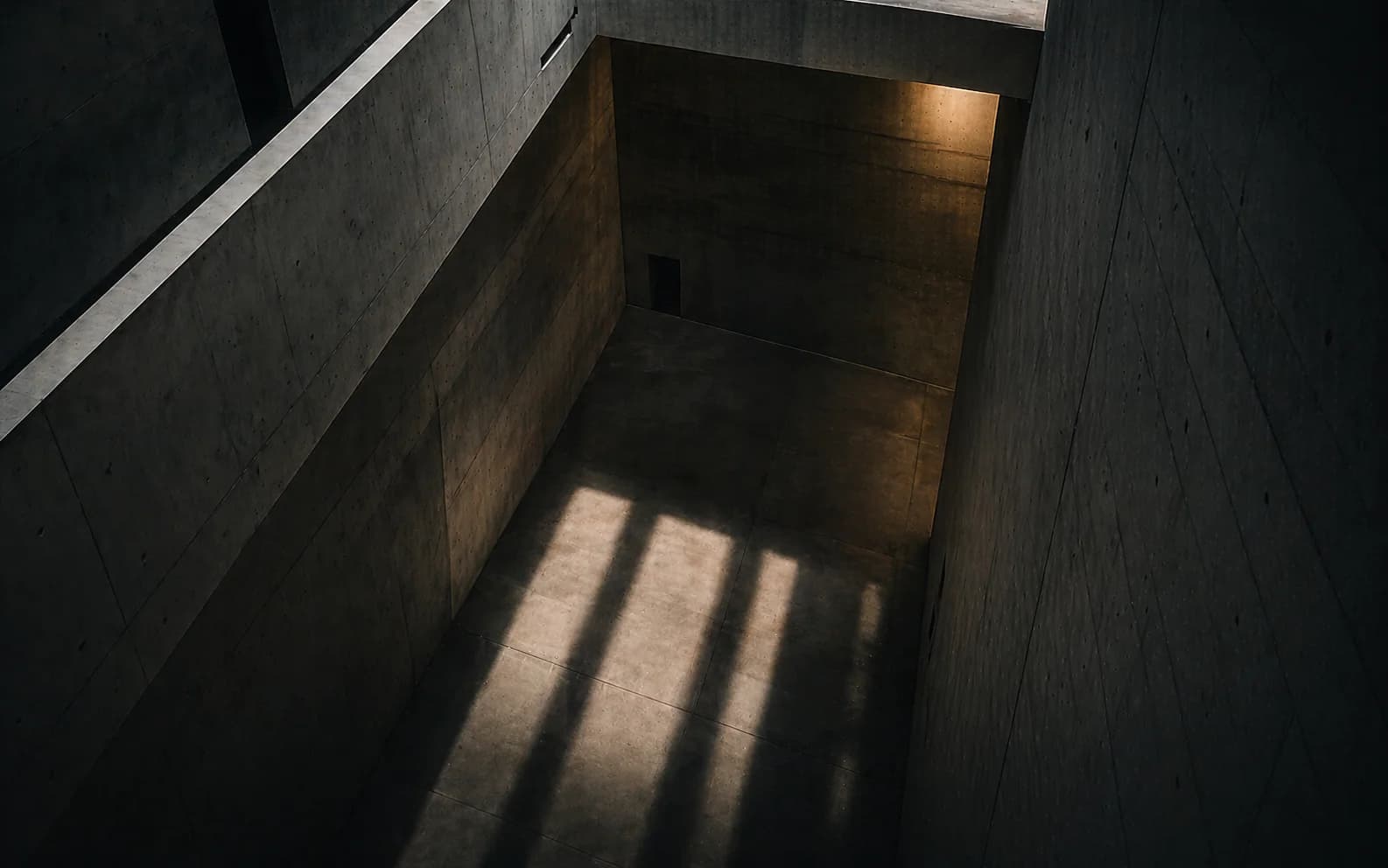 Beton-Schacht mit eintreffendem Lichtstreifen — Metapher für Engpässe an Übergaben